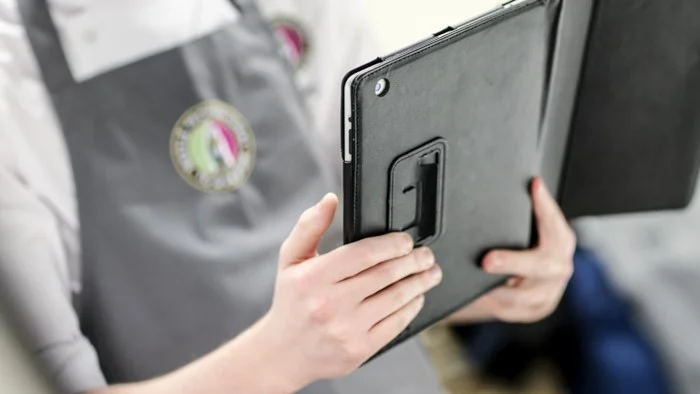 Toque contestant holding an iPad