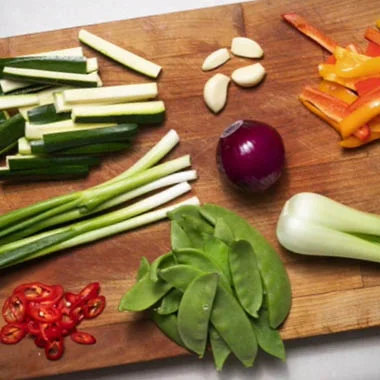 Vegetables part of a vegan restaurant menu, placed on a wooden top)