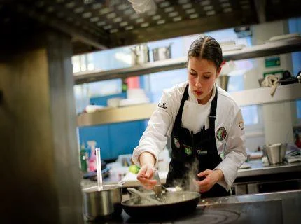 Toque d'Or apprentice cooking in a kitchen