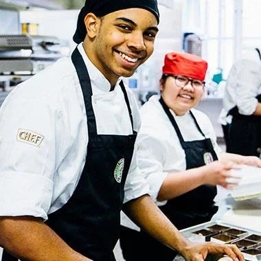 Student working in a professional kitchen participating in the Nestlé Professional's support of sustainable futures program
