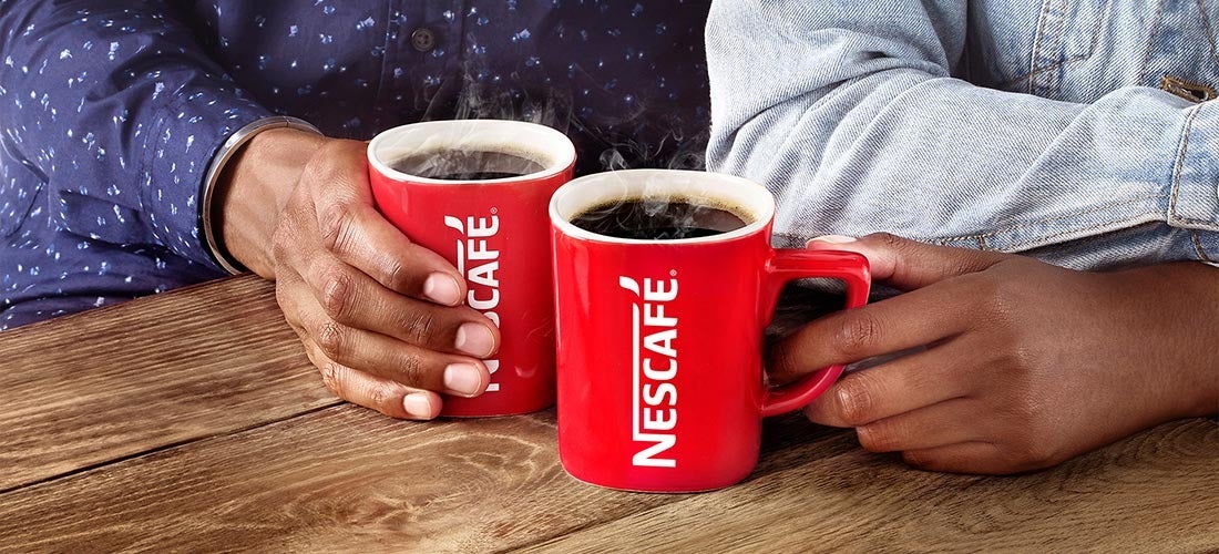 two people enjoying a cup of Nescafé coffee at their workplace