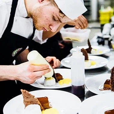 Student chef plating up dishes at the heats of Nestlé Professional's Toque d'Or competition