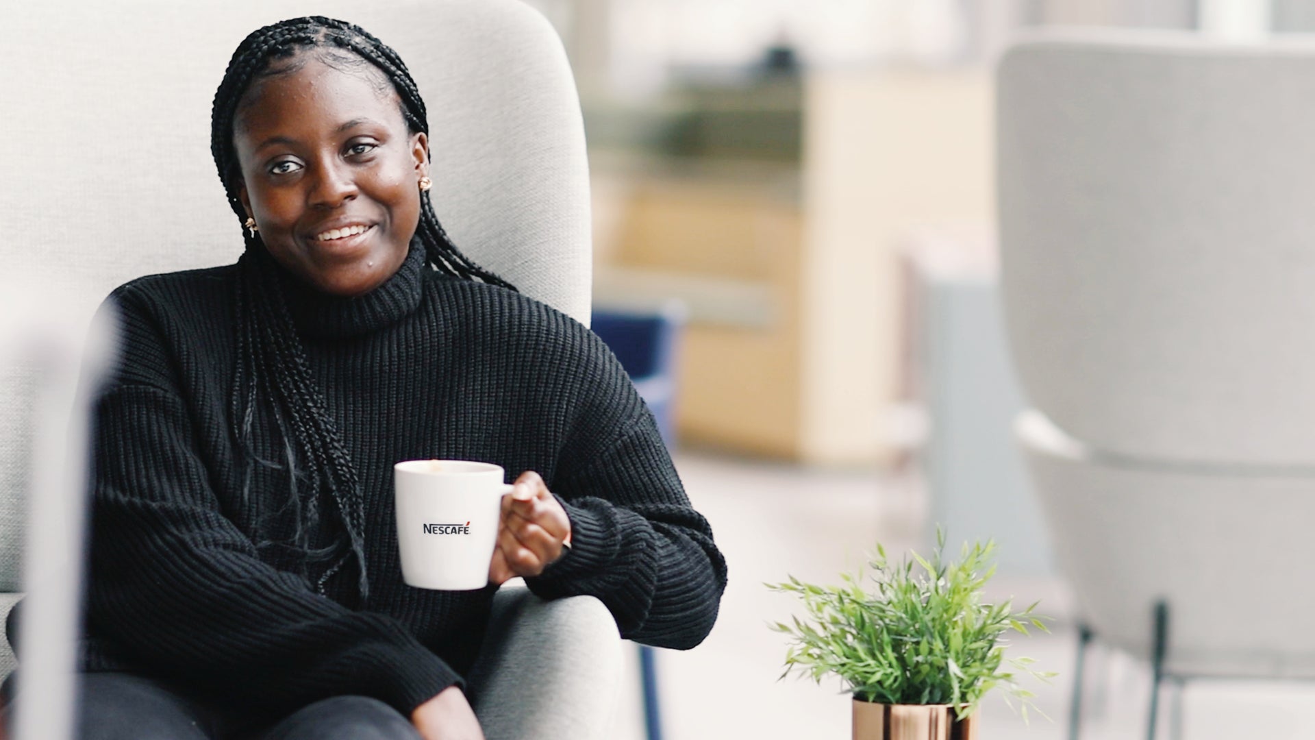 woman sat on chair with coffee