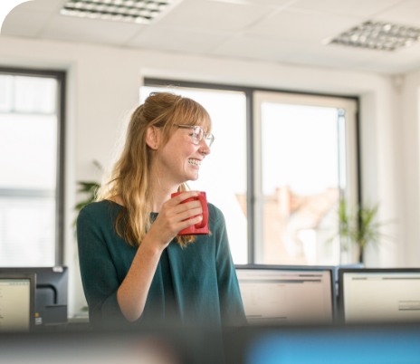 woman drinking NESCAFE in her office
