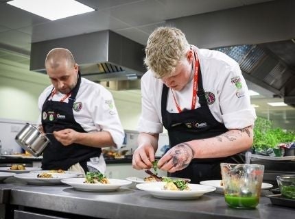 Two competitors plating their dish