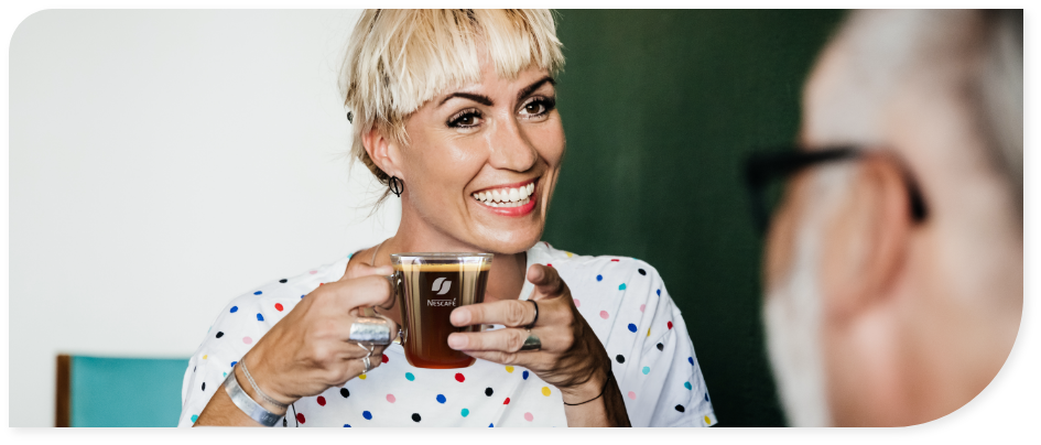 woman drinking NESCAFE in the office