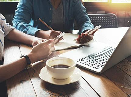 people working while drinking coffee