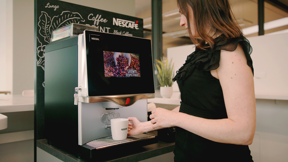 woman making coffee with nescafe machine
