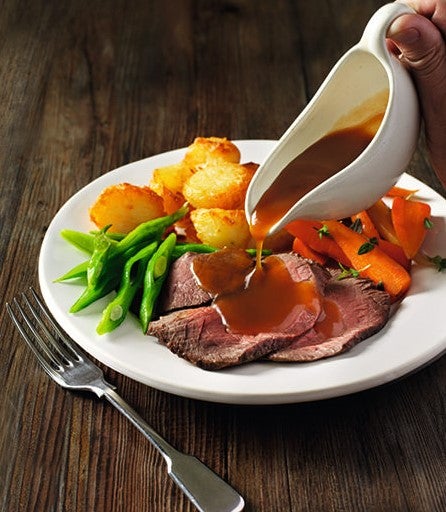 Gravy poured over roast dinner