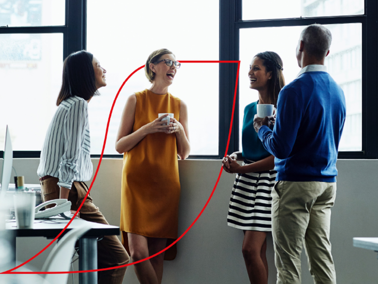 Four people standing chatting with coffee