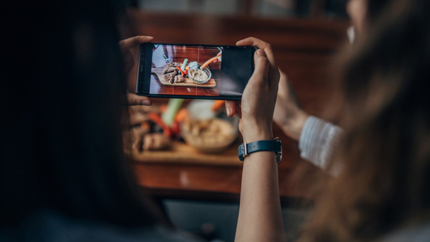 Person taking photo of food