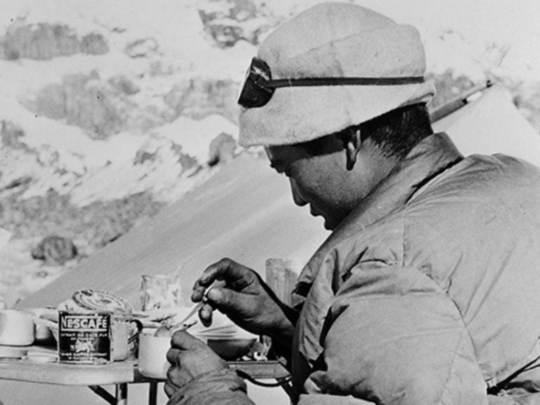 Black and white photo of a soldier drinking coffee