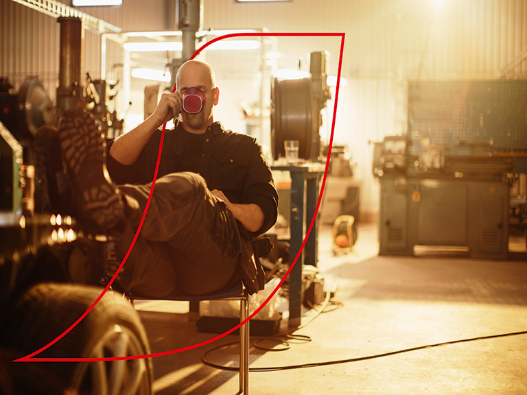 man drinking coffee with feet up