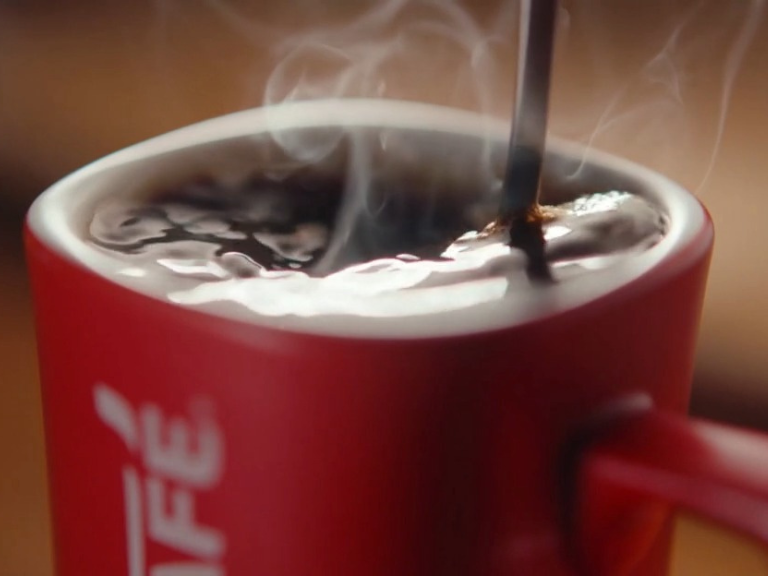 steaming coffee in red NESCAFÉ mug