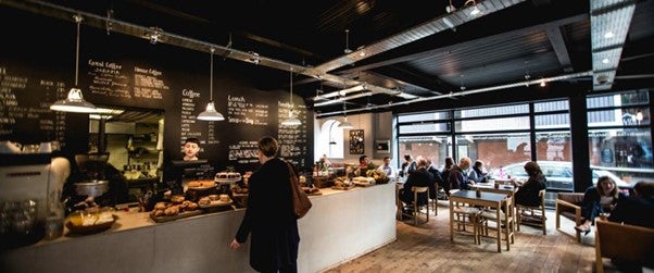 Person waiting at coffee shop counter