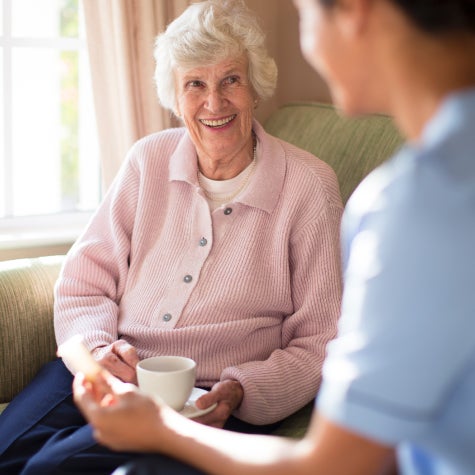 Woman smiles with nurse