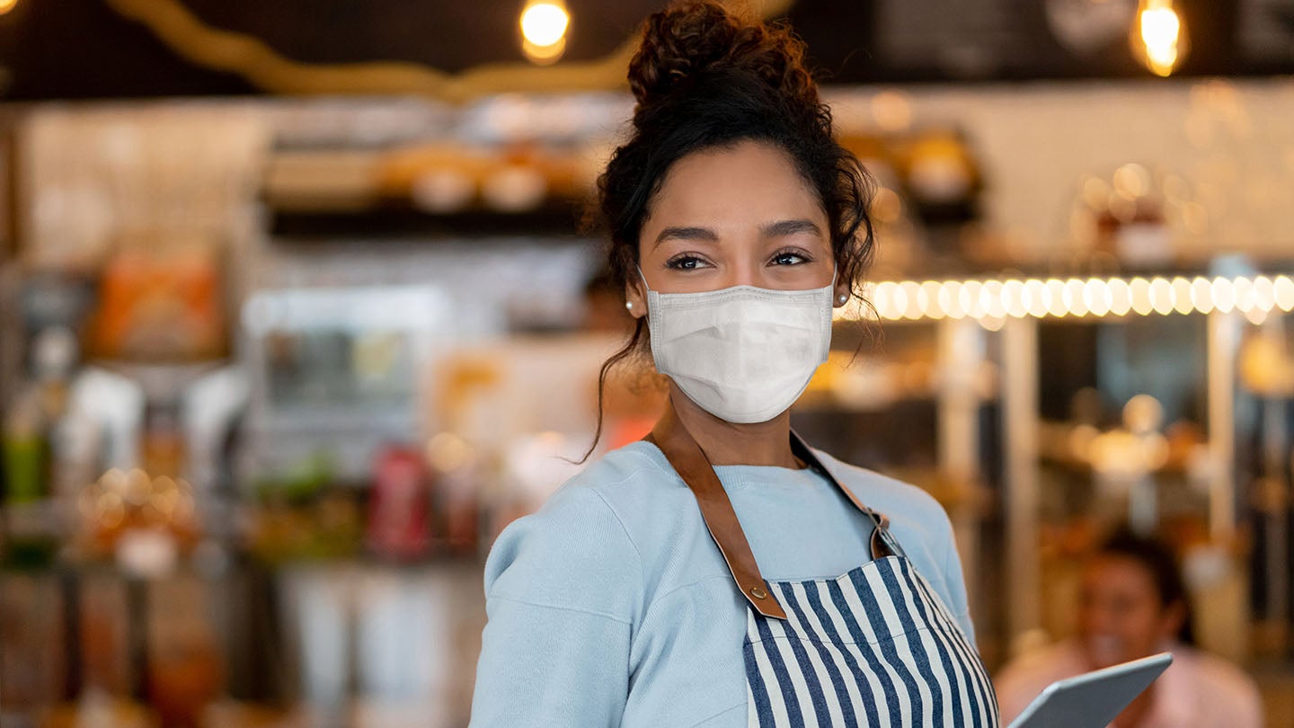 Woman wearing a mask in restaurant