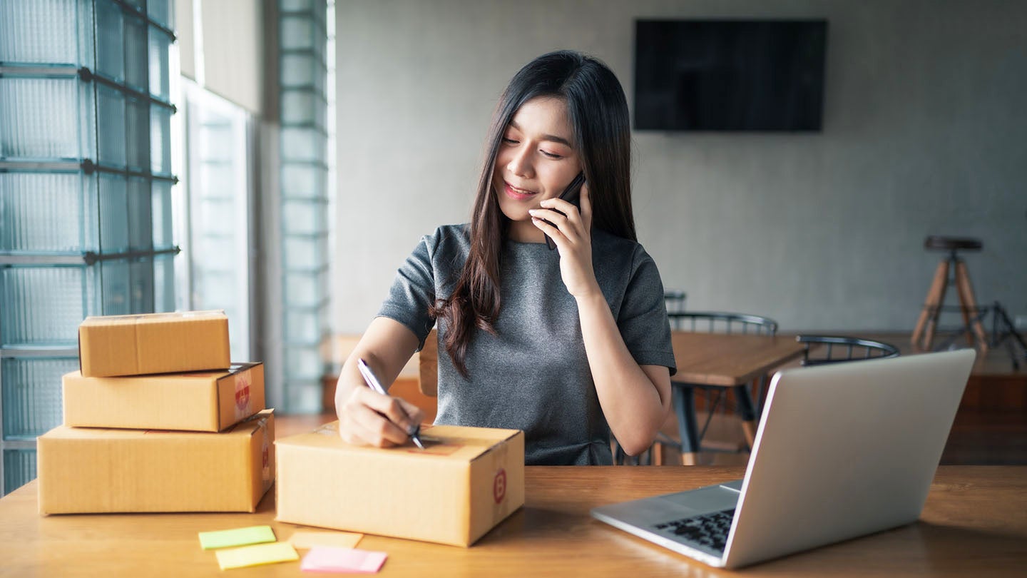 Woman signing a parcel