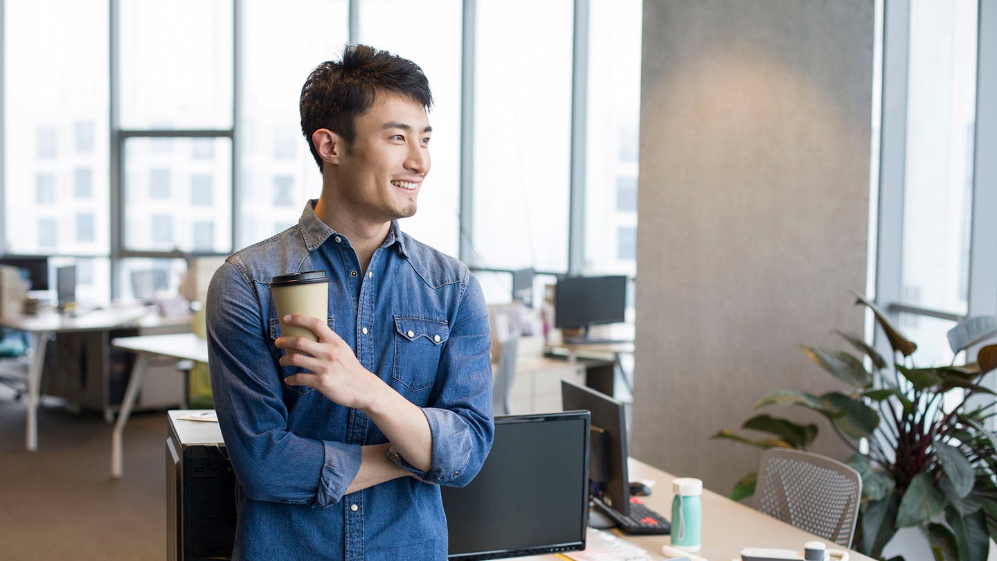 A man holding a coffee cup