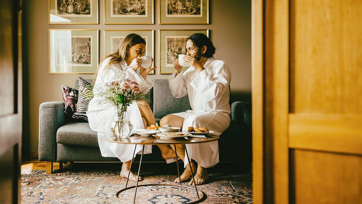a couple drinking coffee in a hotel