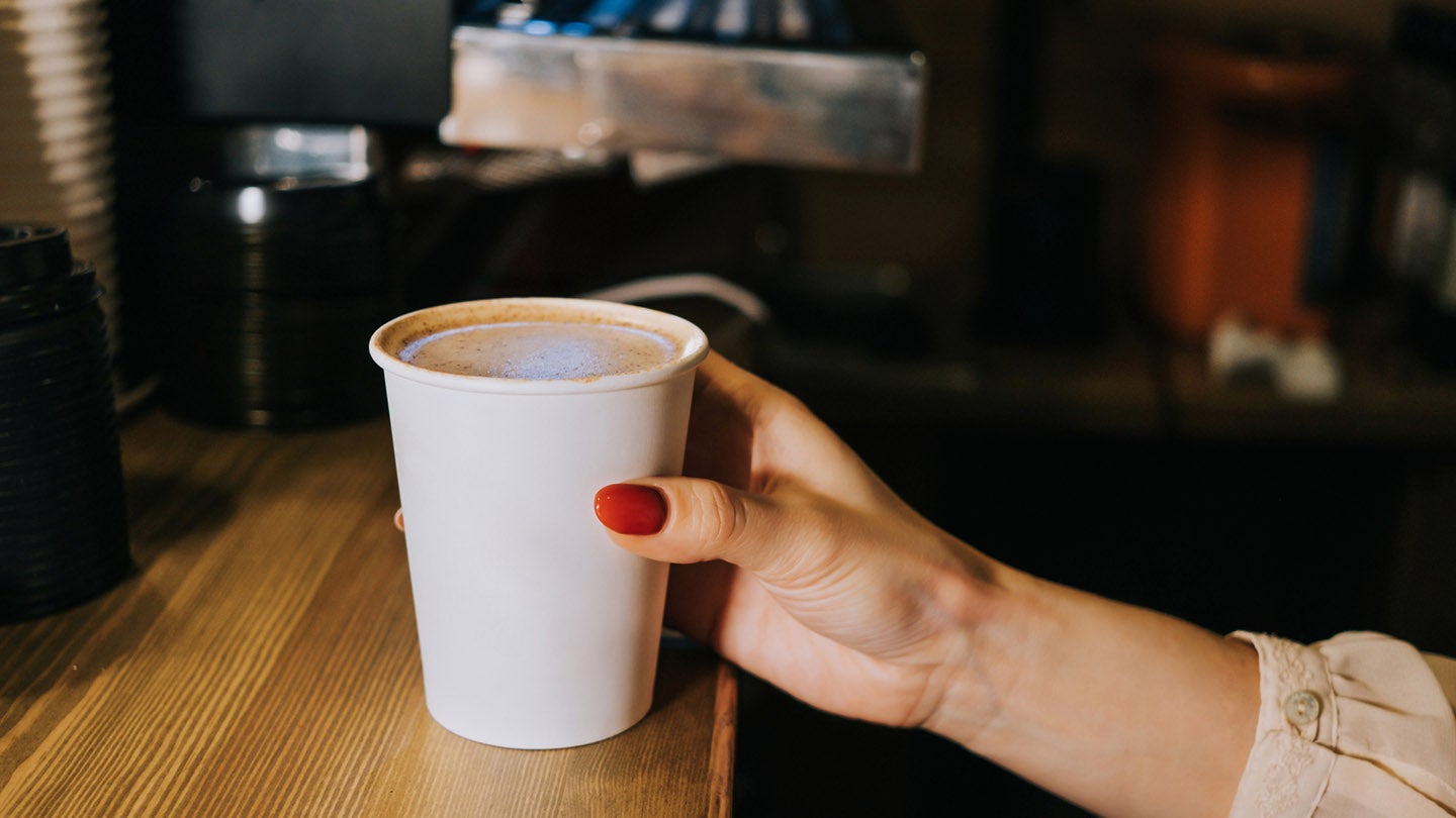 Person holding coffee cup