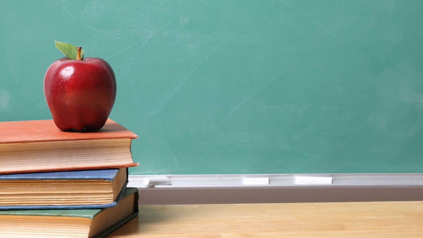a stack of books with an apple on top