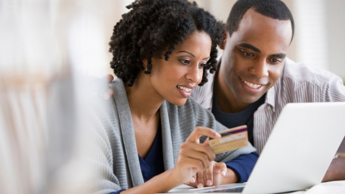 Two people looking at their laptop
