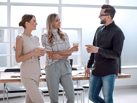 Colleagues chatting and drinking coffee
