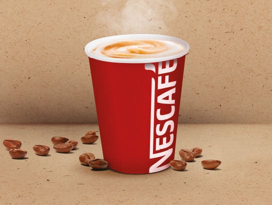 steaming coffee drink in NESCAFÉ cup