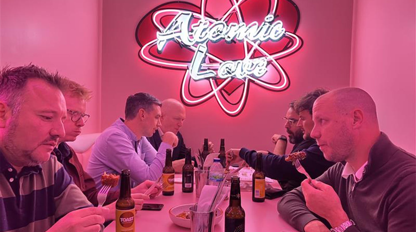 crowd of people standing around tables and food exploration tour