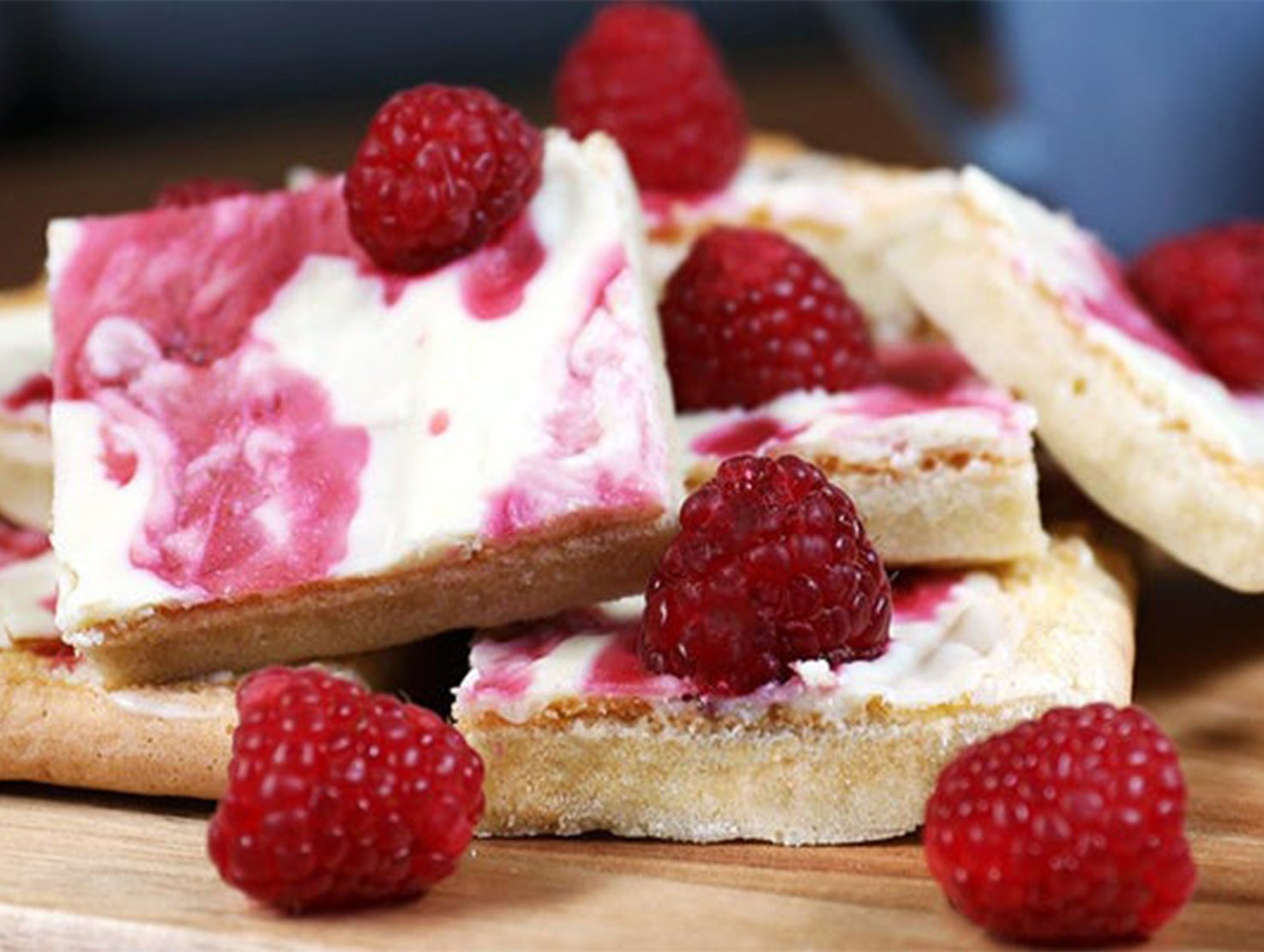 milkybar traybake with raspberries on a table