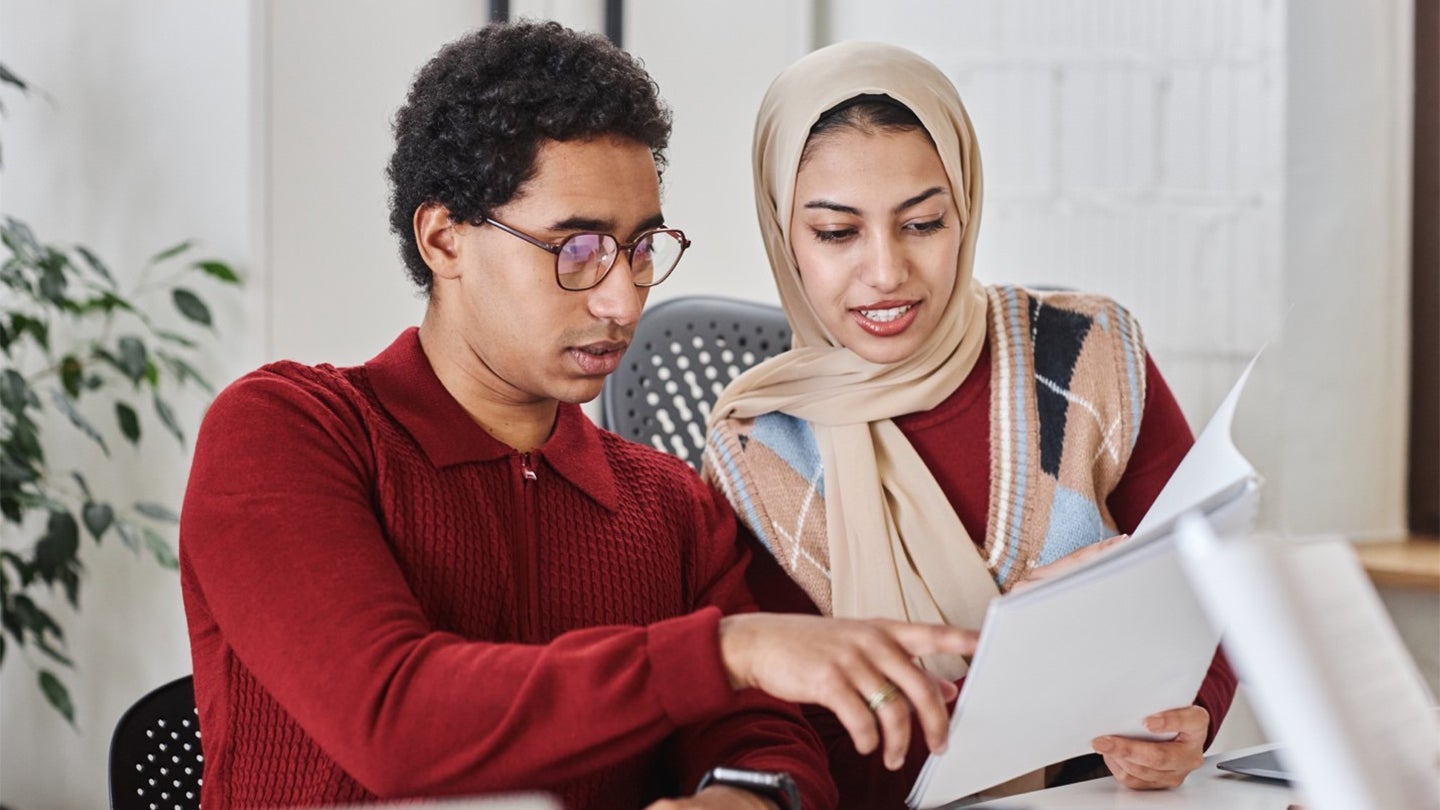 manager and employee looking at folder