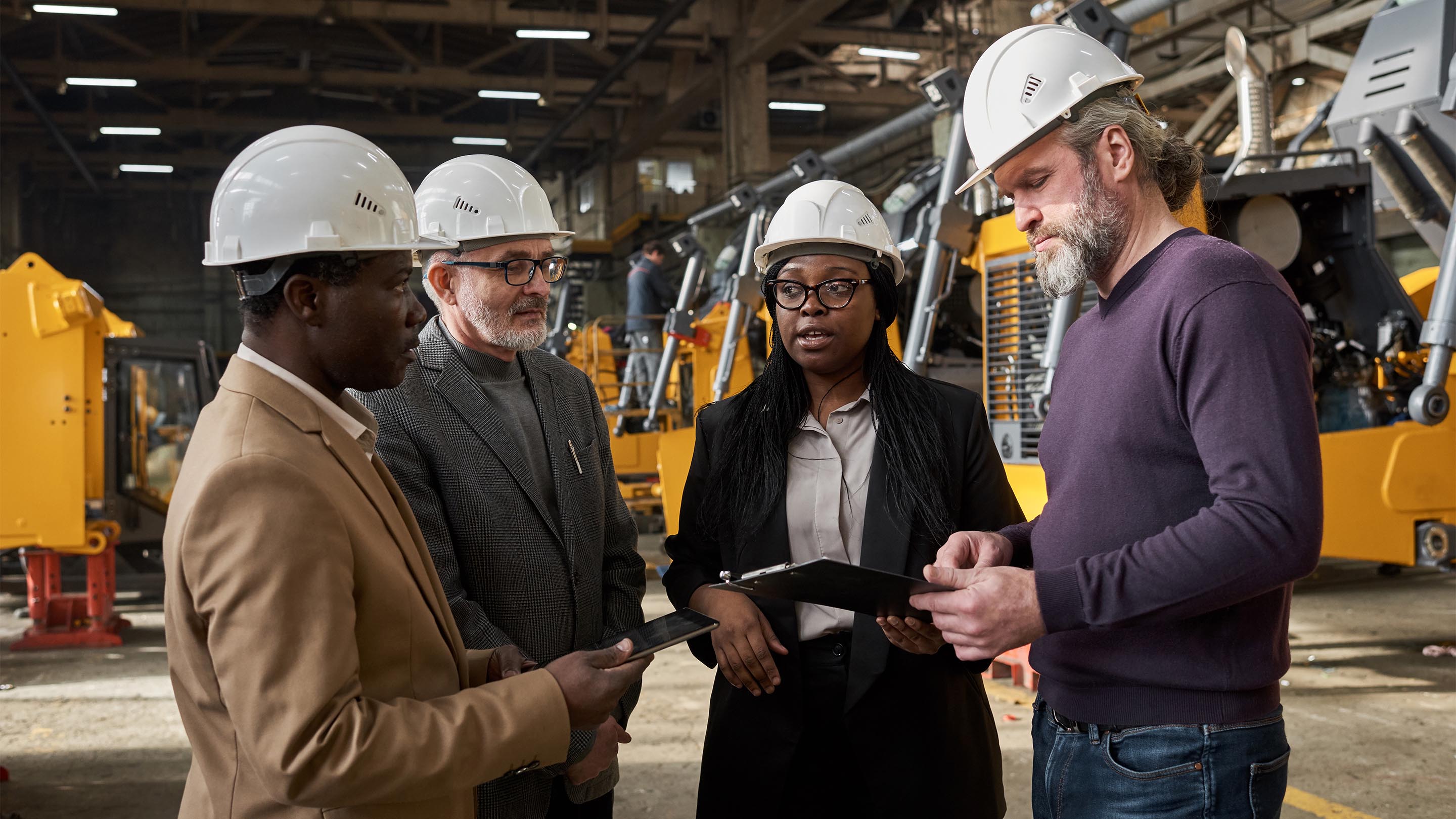 group of colleagues meeting on the factory floor