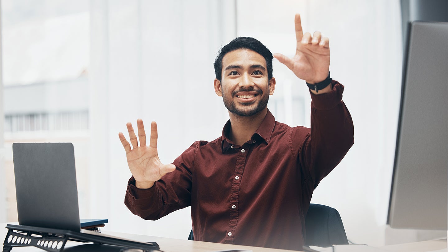 manager sitting at a desk explaining his vision
