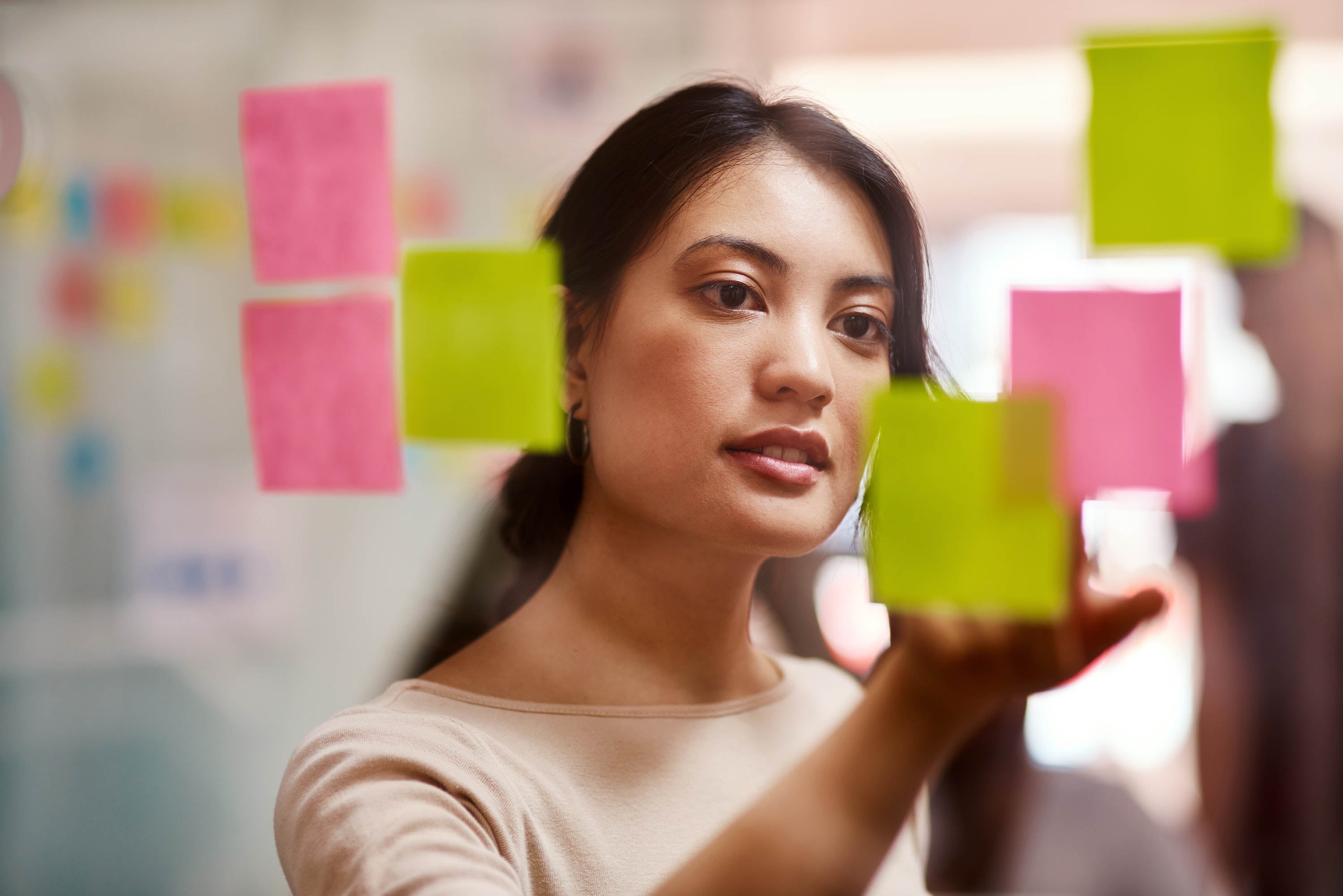 woman in front of a wall with post-it notes