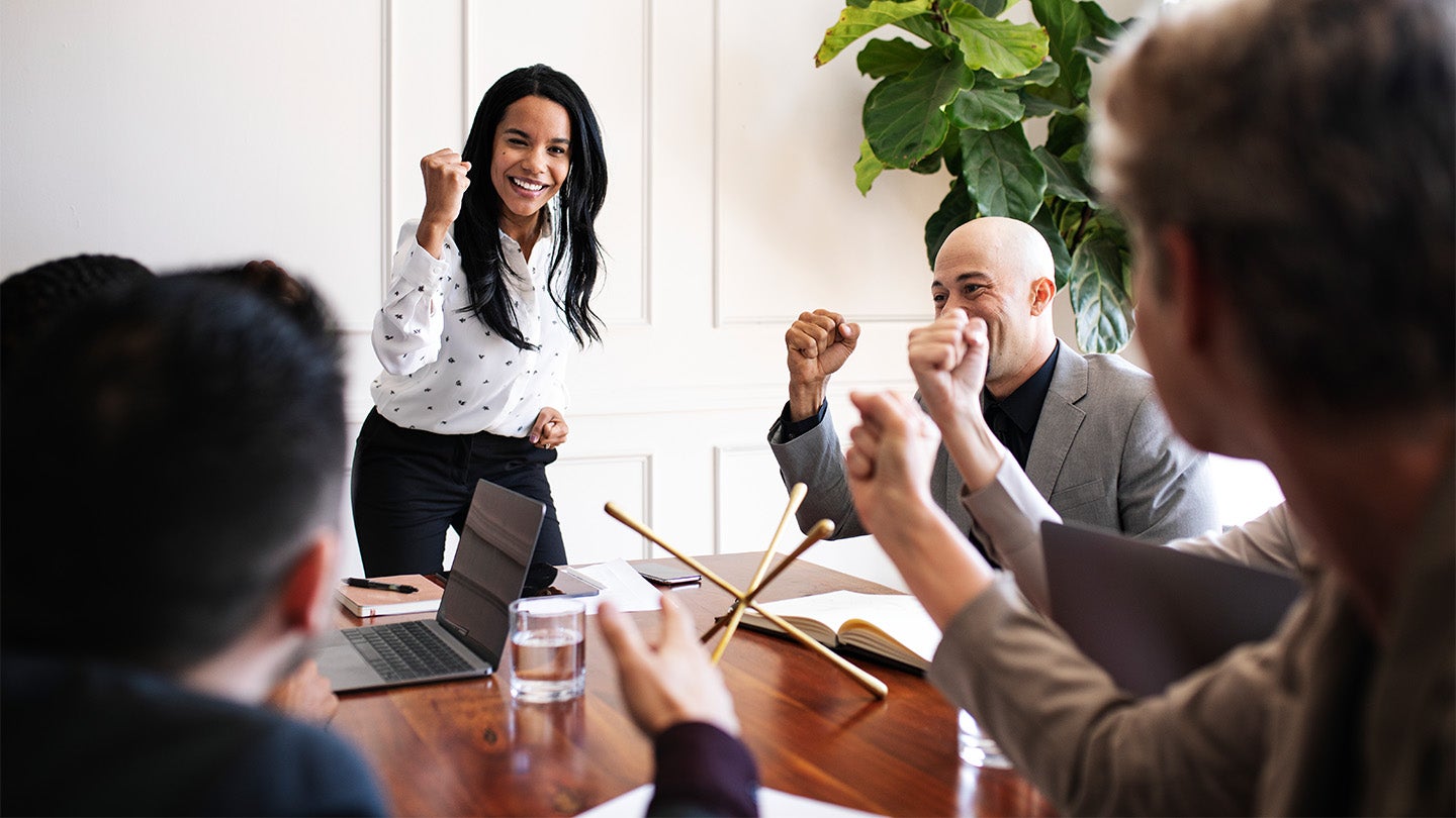 employees and manager around a meeting table
