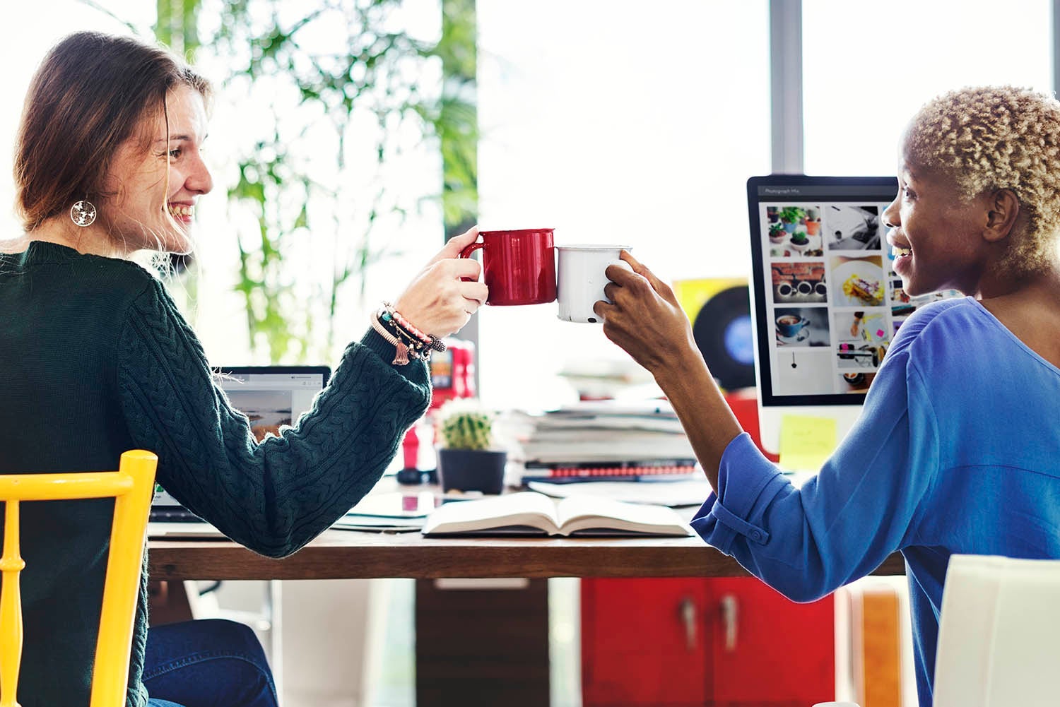 employees enjoying a cup of coffee using a reusable cup