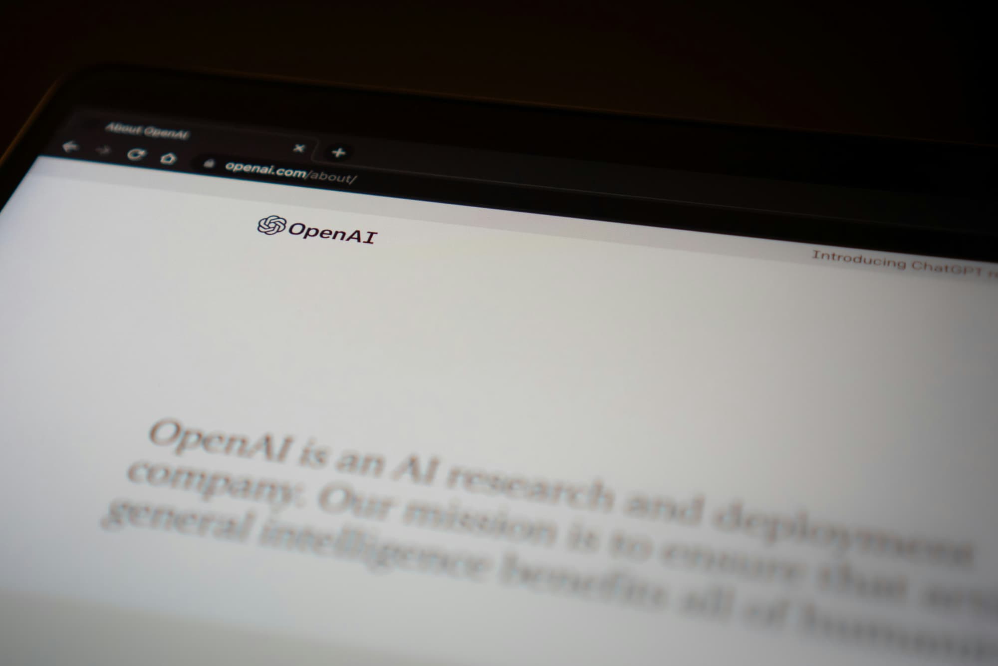 A laptop screen showing the OpenAI Website