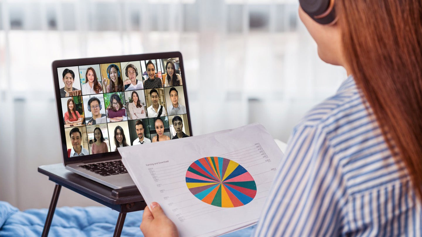 woman leading a virtual meeting on her laptop from home