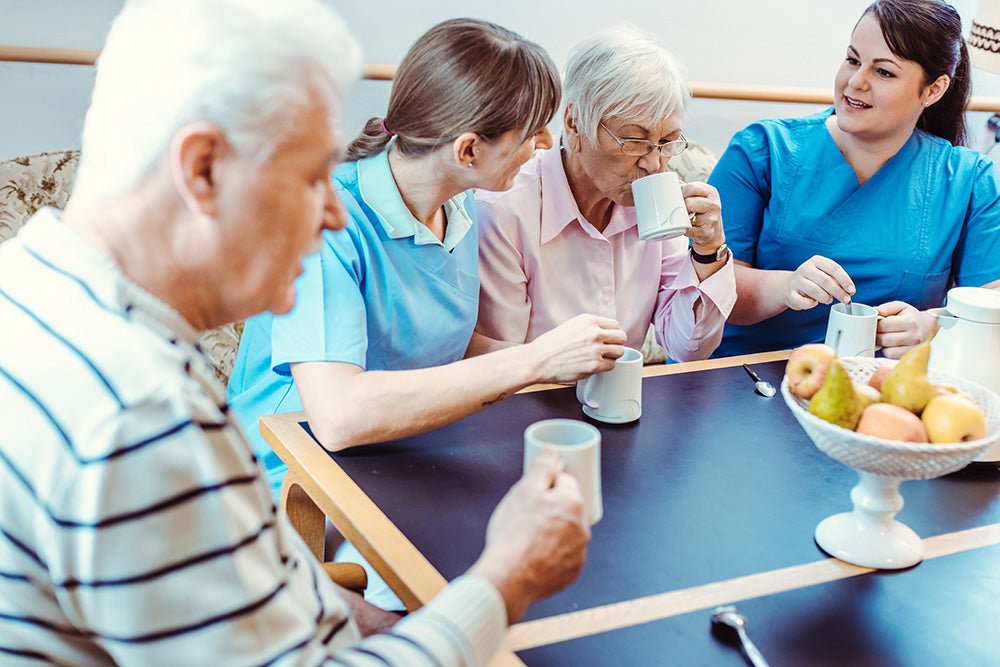 group-of-staff-elderly-carehome-drinking-coffee