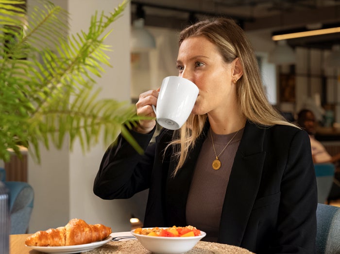 Woman enjoying cup of coffee