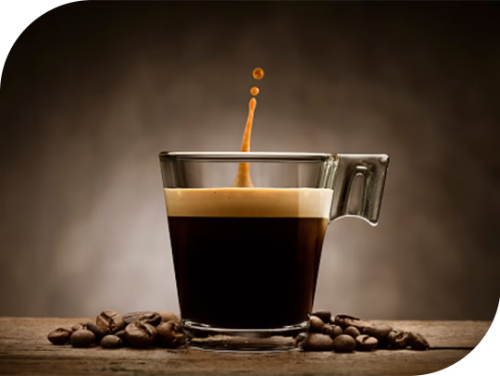 espresso coffee cup with coffee being poured in