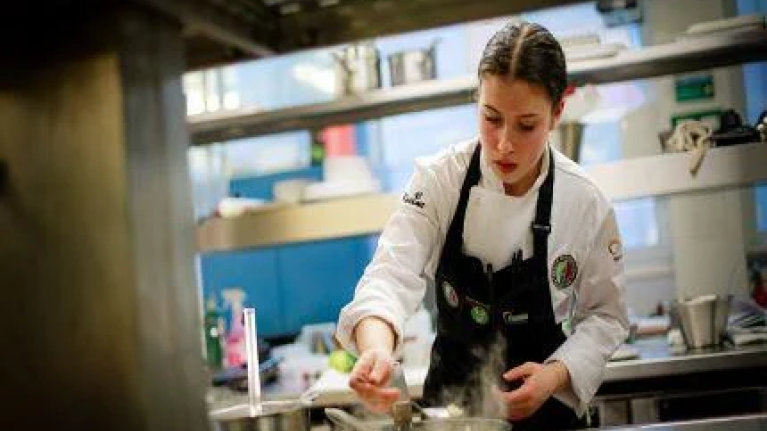 Toque d'Or apprentice cooking in a kitchen