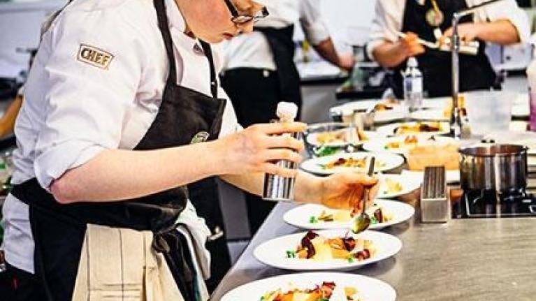 Student plating up in a professional kitchen as part of Nestlé Professional's sustainable futures program Toque d'Or