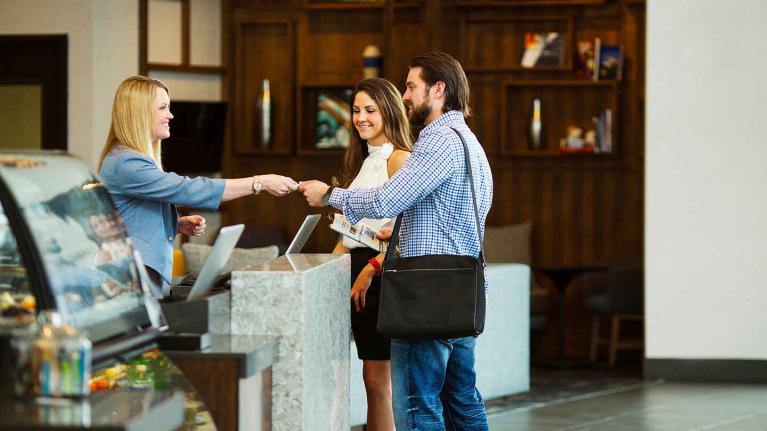 two visitors at a hotel ordering food