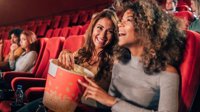 Two women laughing in the cinema