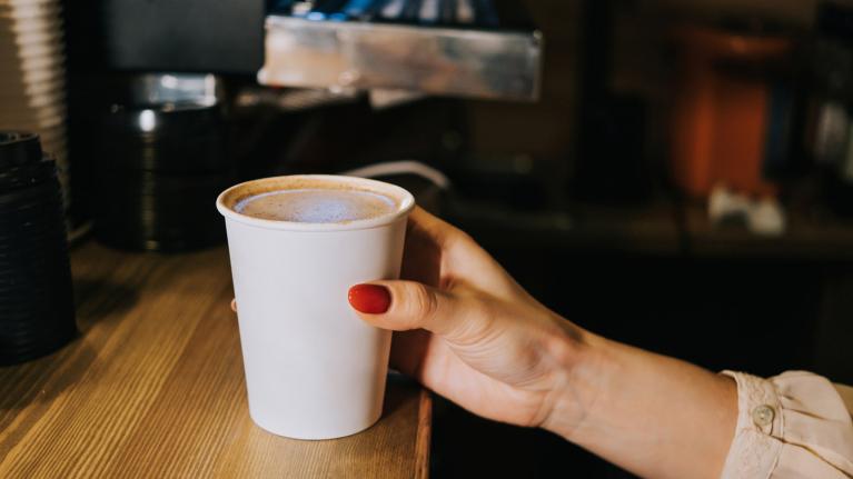 Person holding coffee cup