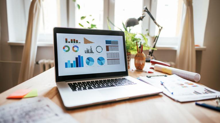 A laptop showing graphs