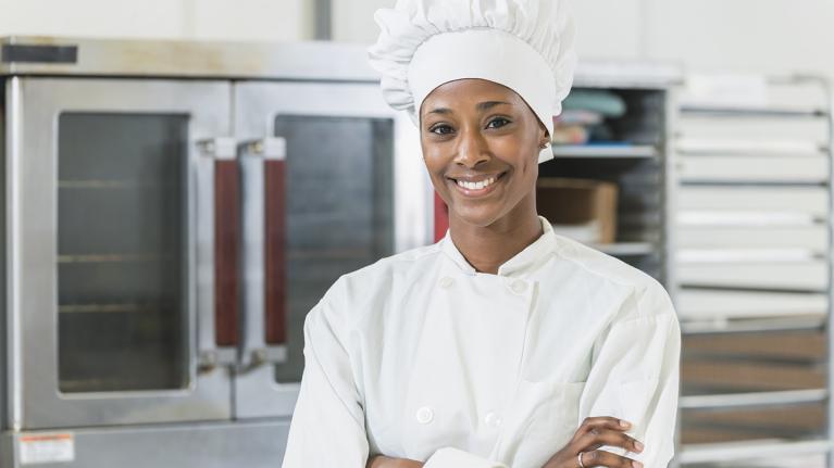 A chef smiling in a kitchen
