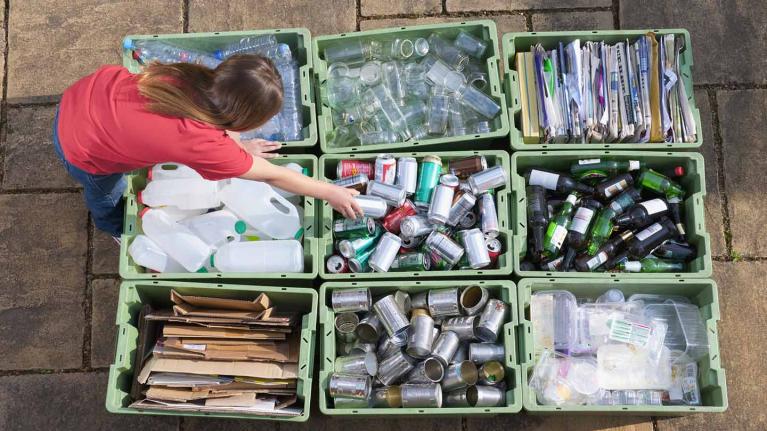 A person sorting through recycling